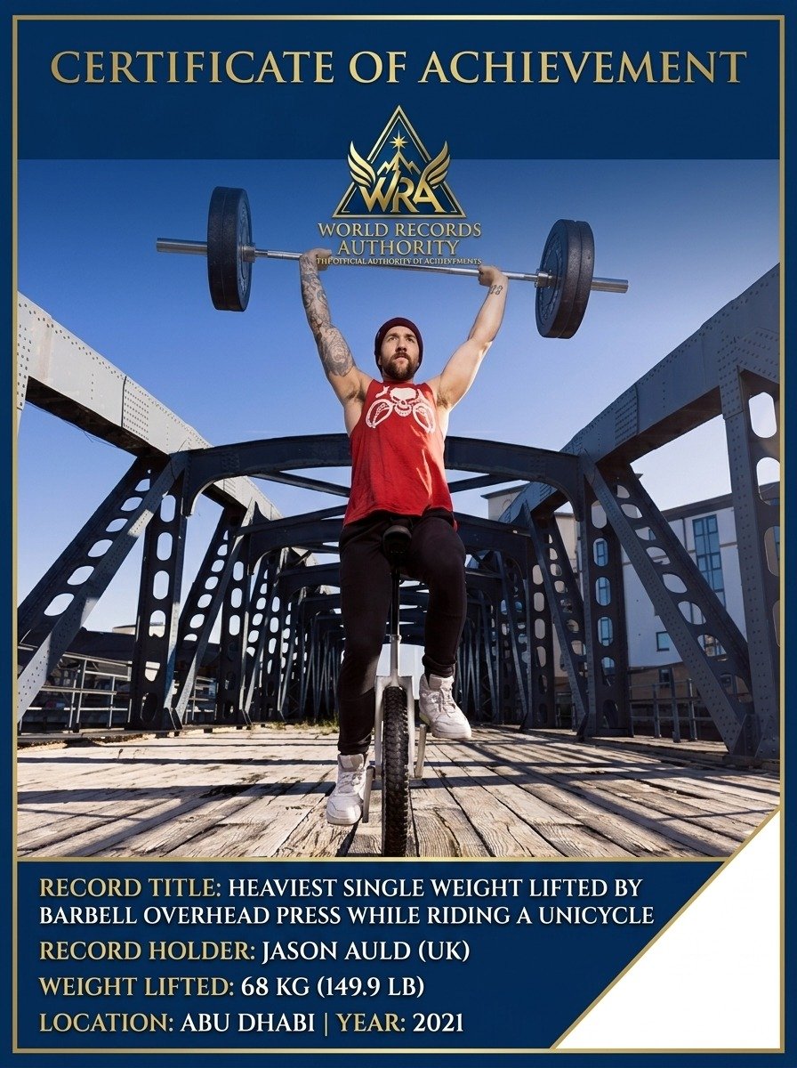 Jason Auld barbell overhead press on unicycle
