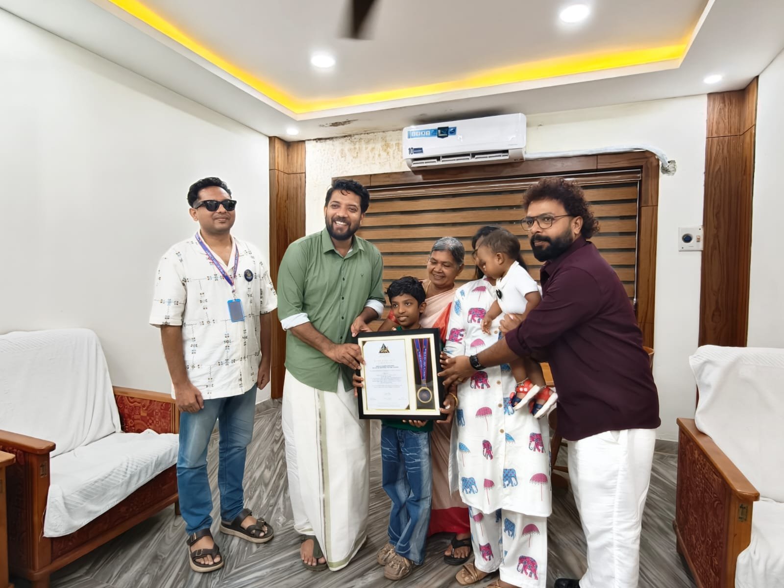 Biju P receiving the World Records Authority certificate with his family